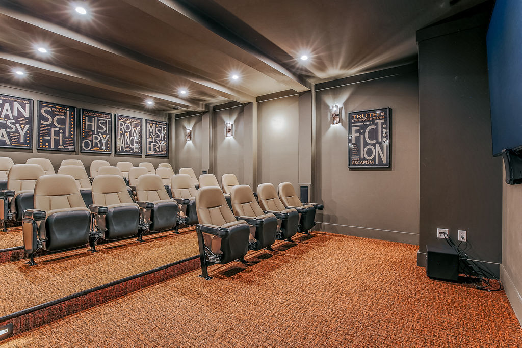 a rehearsal room with a projector screen and chairs