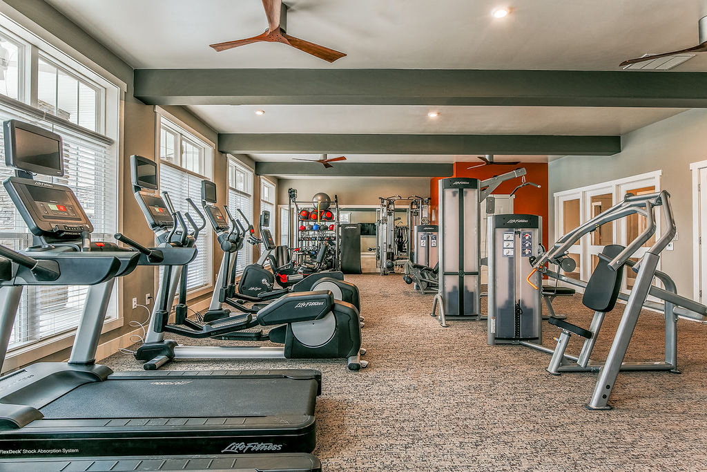 a gym with treadmills and other exercise equipment