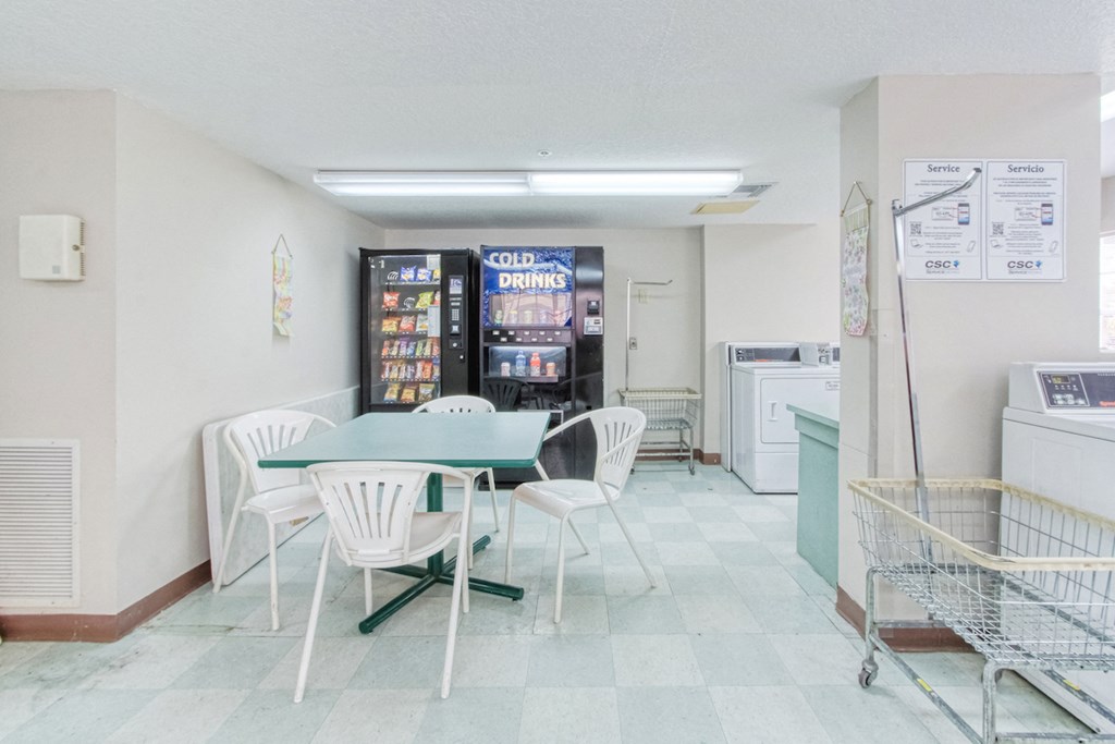 sitting area with drink and snack machines in laundry center