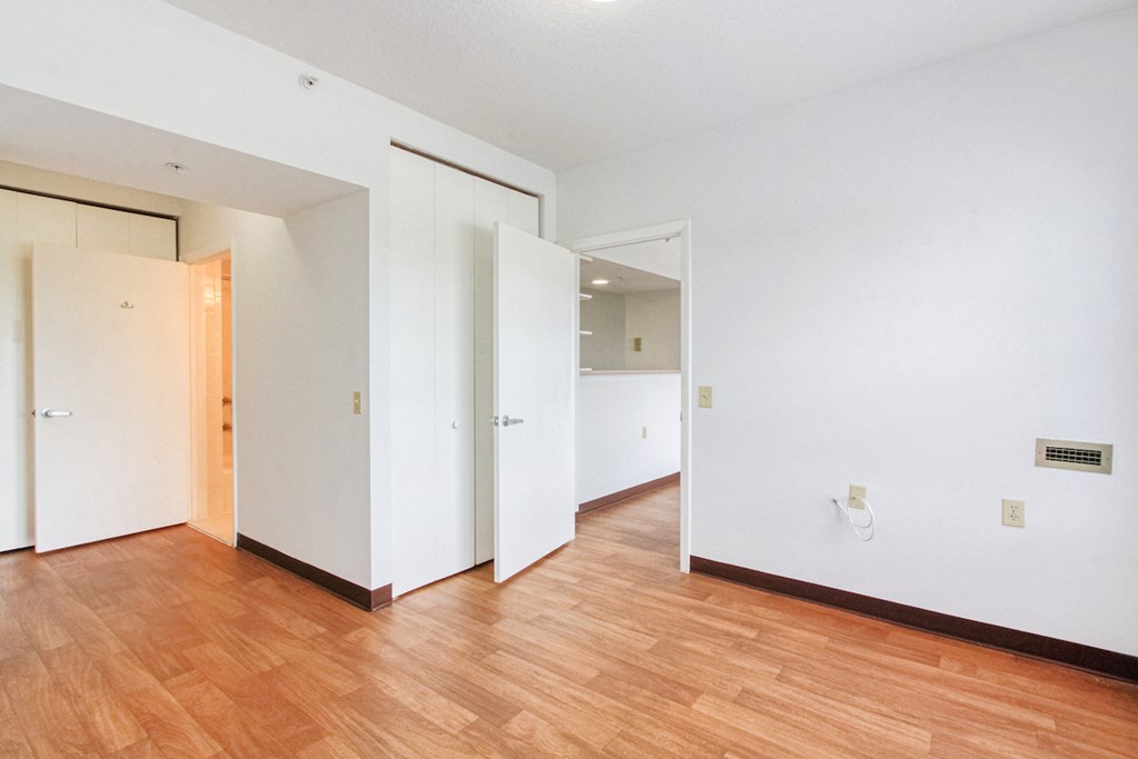 bedroom with hardwood-styled flooring and bathroom entrance