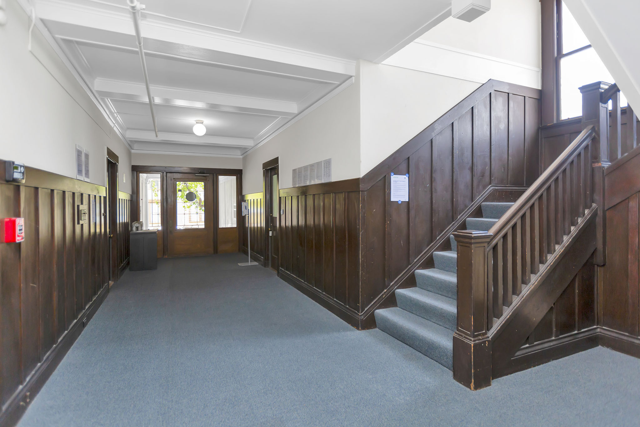 A long hallway with a staircase on the right side.