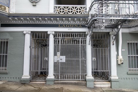 A building with a gate and a sign that says Laguna.
