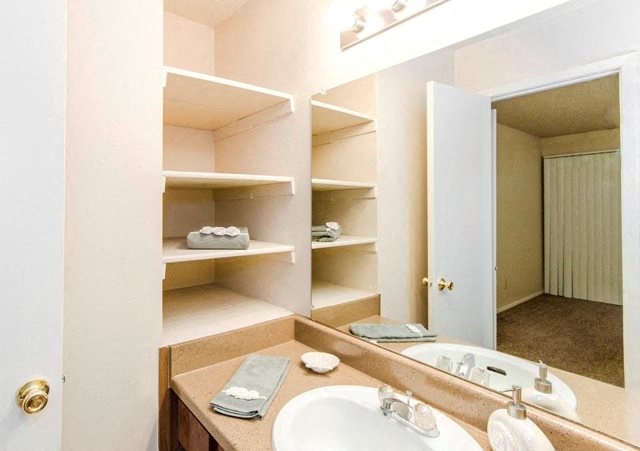 Bathroom with Oversized Vanity Mirror, Overhead Lighting, and Built-In Storage