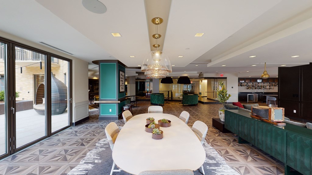 a dining room with a white table and chairs and a lobby
