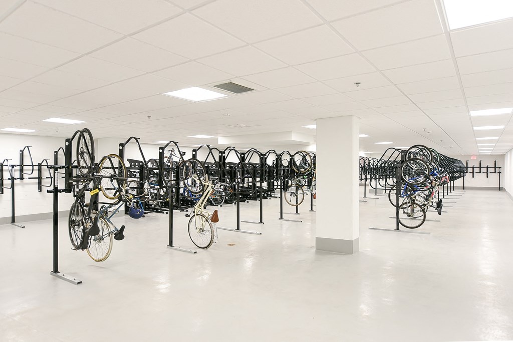 a large room filled with lots of bikes on racks