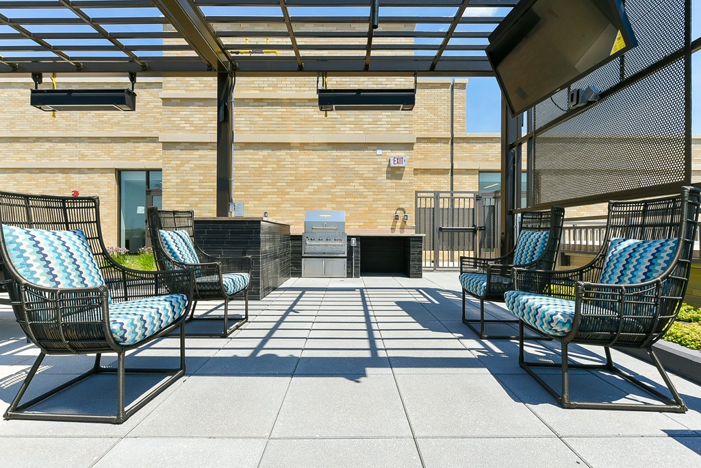 an outdoor patio with lounge chairs and a fire pit