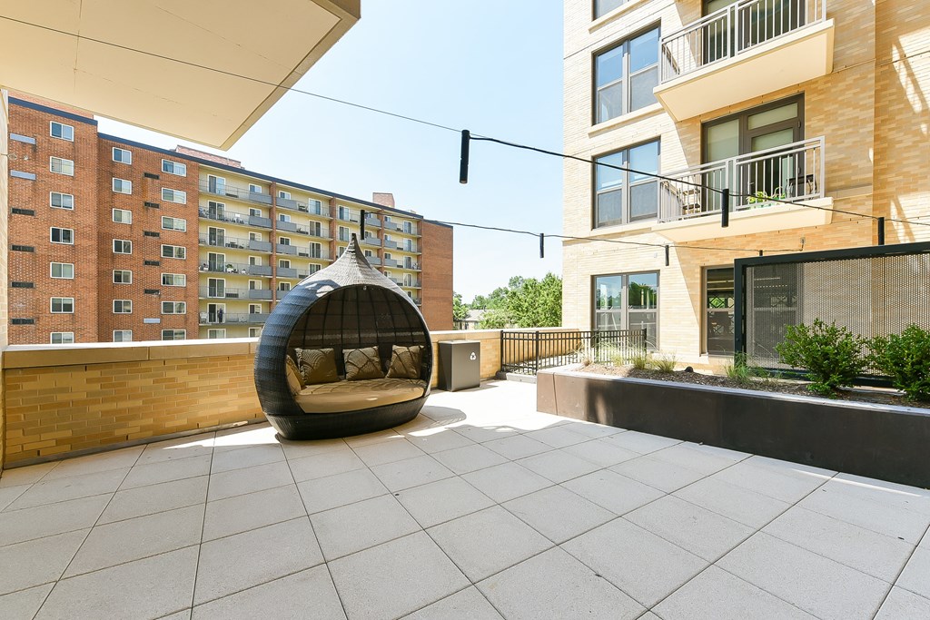 an outdoor seating area with a bean bag chair in front of a building