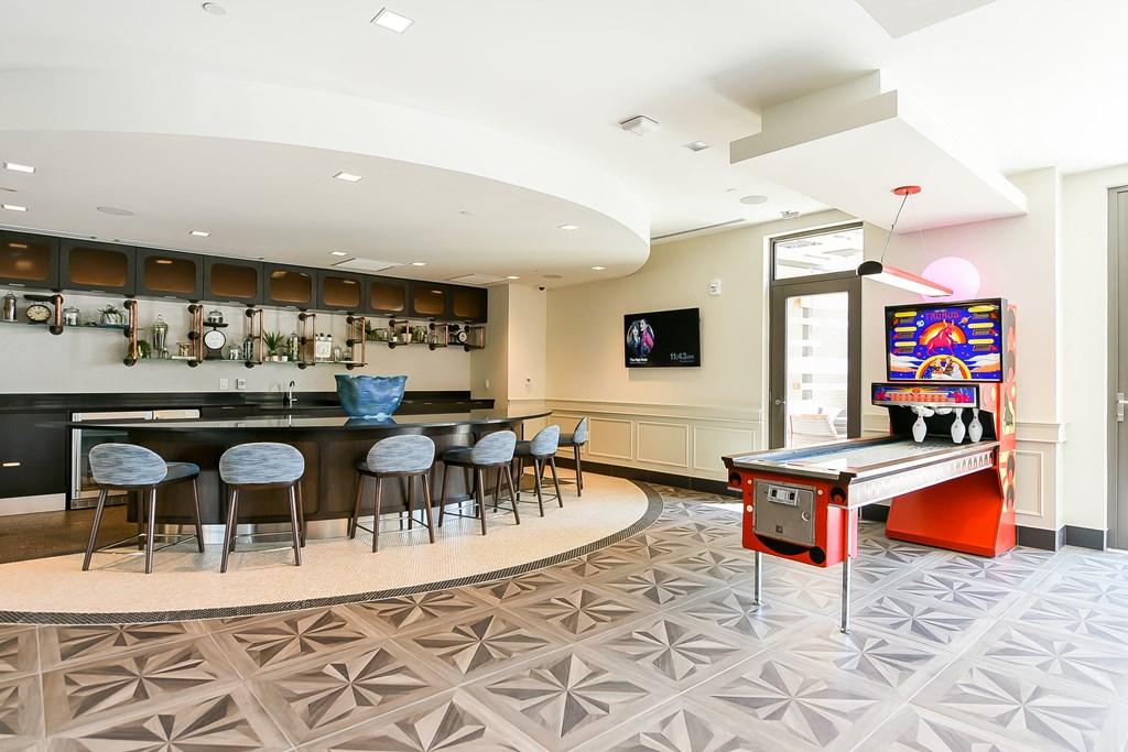 a game room with a pool table and bar