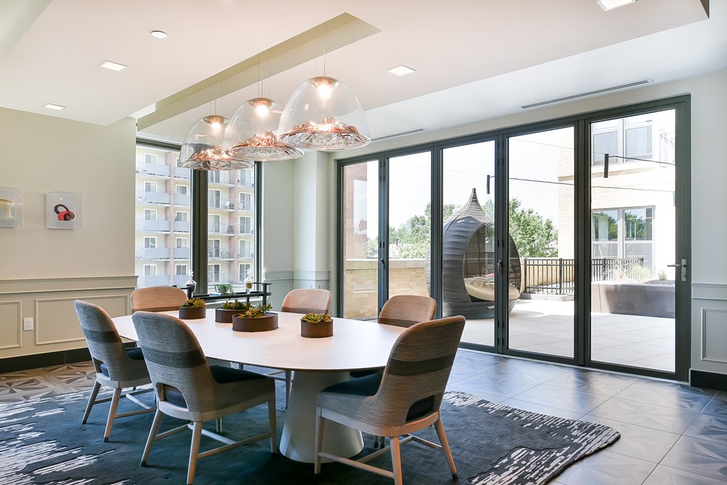 a dining room with a table and chairs and sliding glass doors