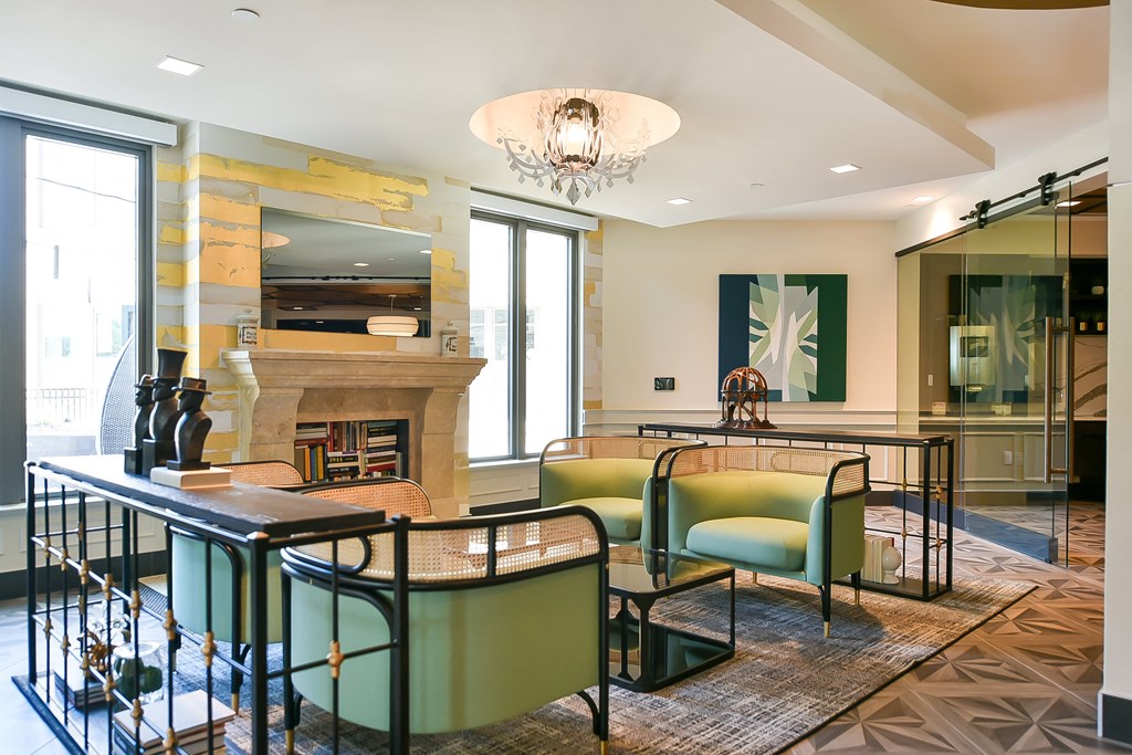 a living room with a table and chairs and a fireplace