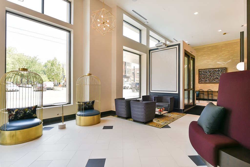 a lobby with couches and chairs and large windows