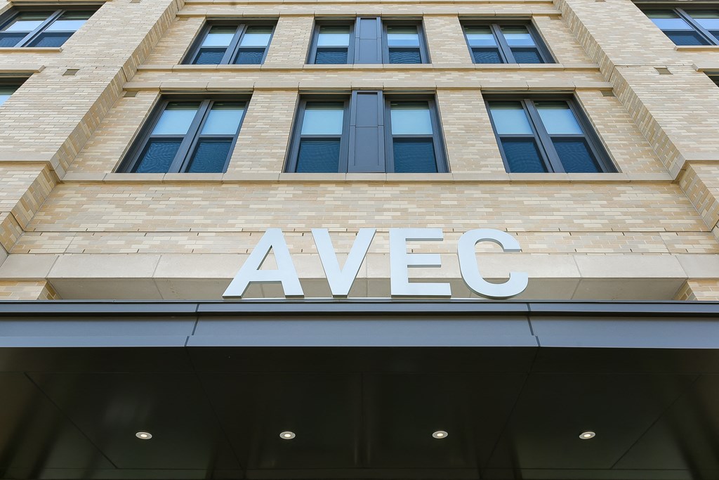 the sign for avec on the side of a building