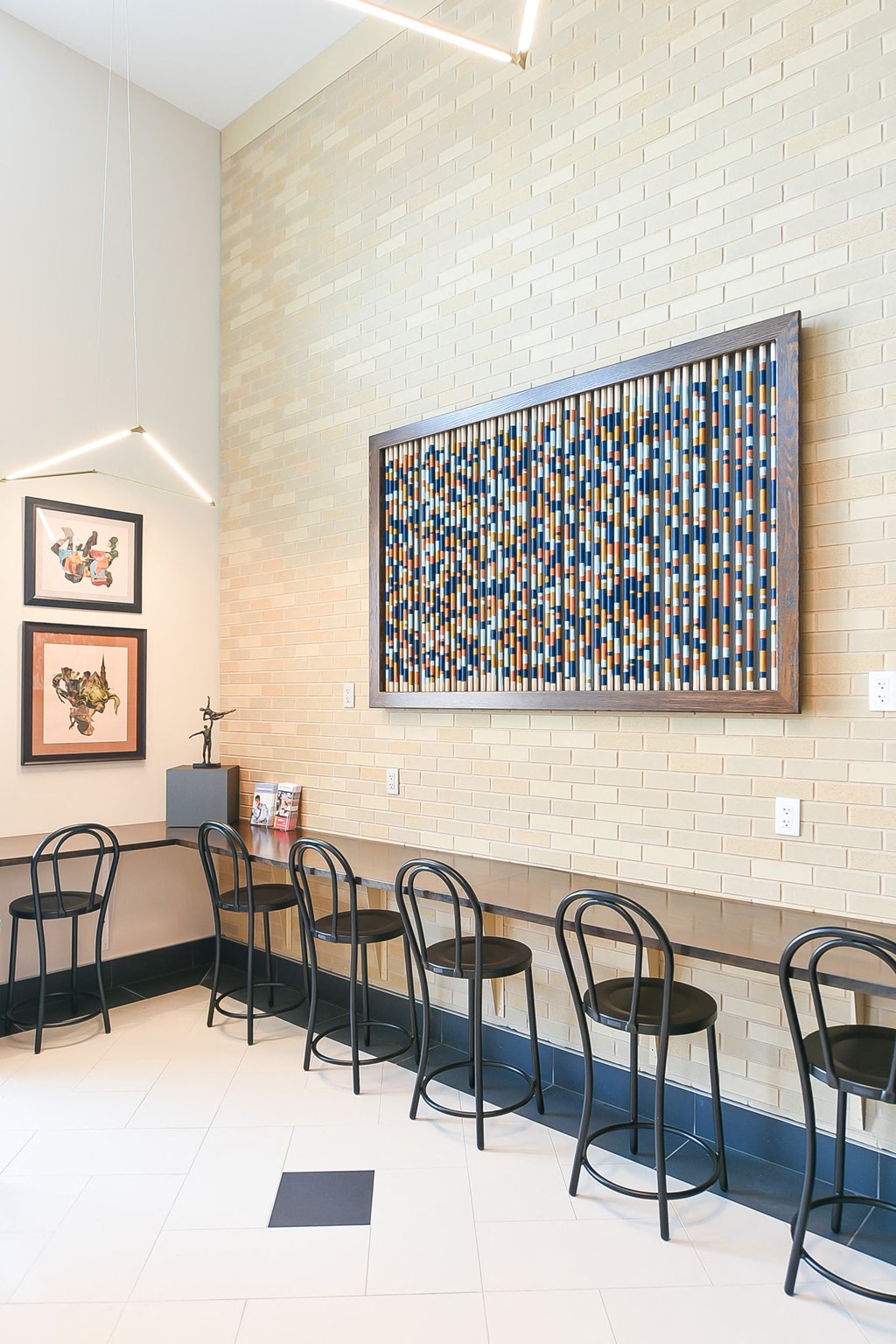a dining room with chairs and a wall with a painting on the wall