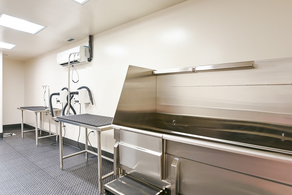 a commercial kitchen with stainless steel counters and stools