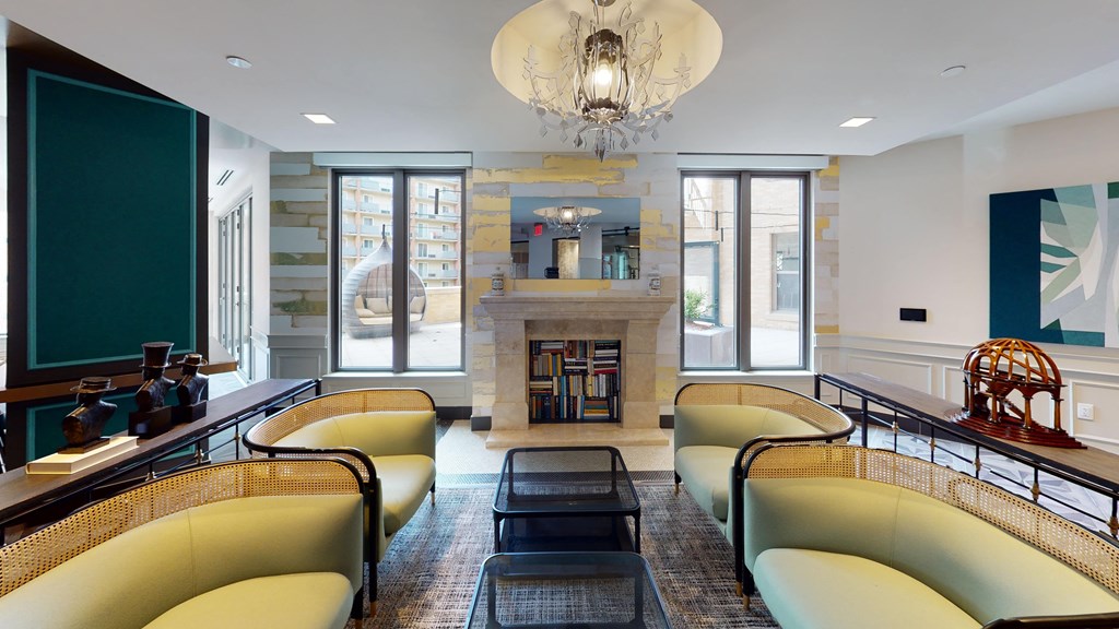 a living room with couches and a fireplace and a chandelier