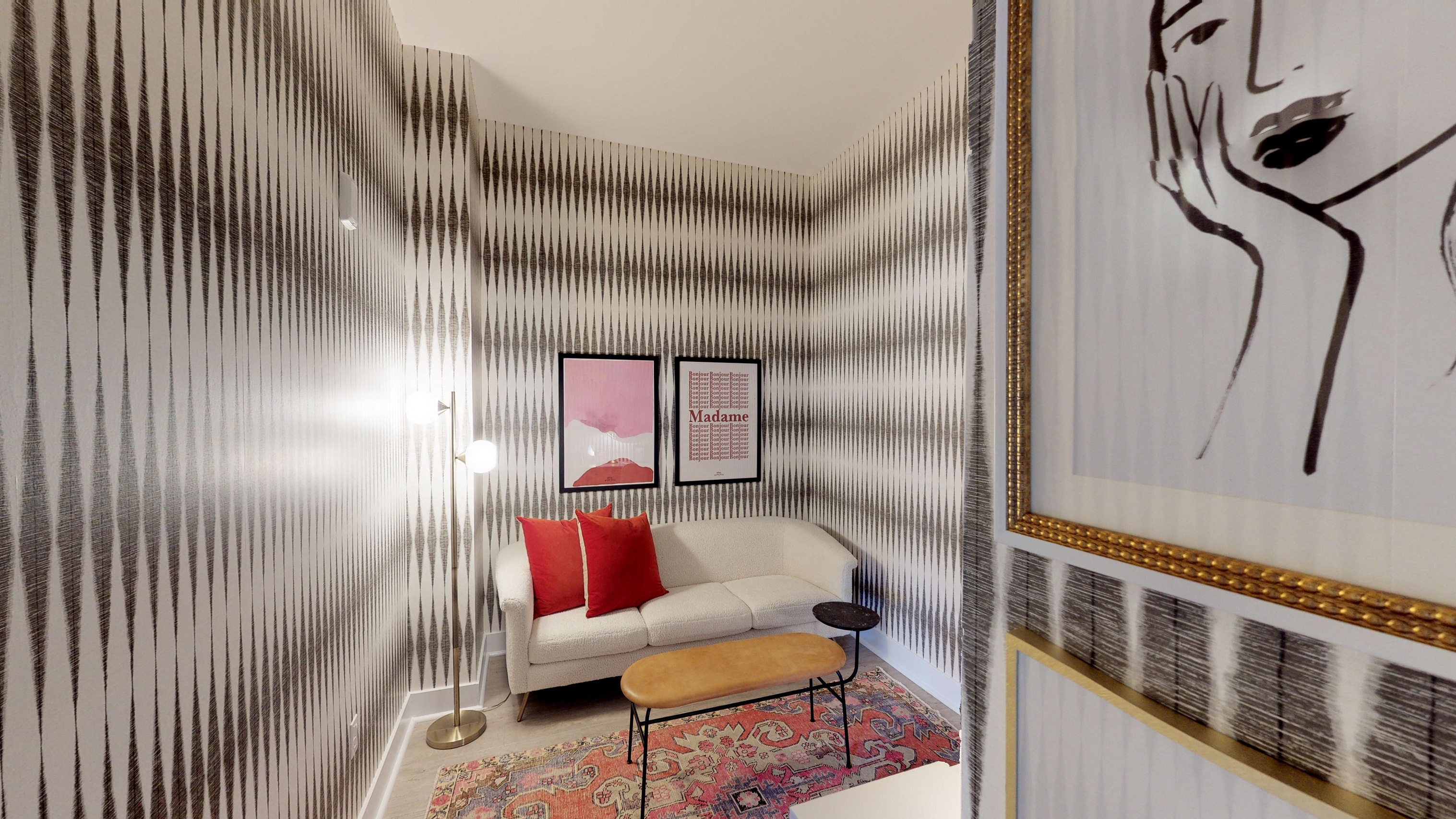 a living room with a couch and a painting on the wall