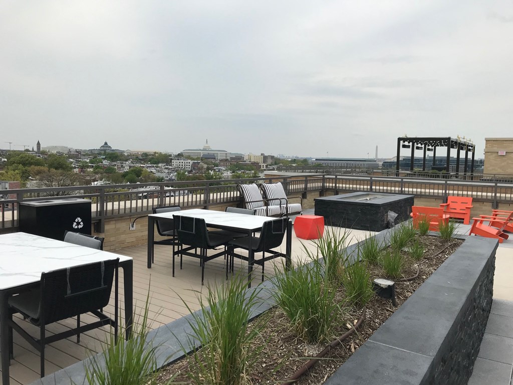 the roof terrace of the epicurean with tables and chairs and a grill