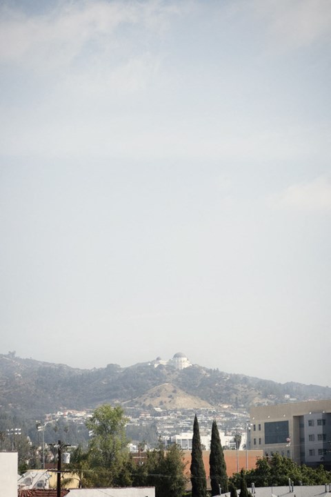 A cityscape with a mountain in the background.