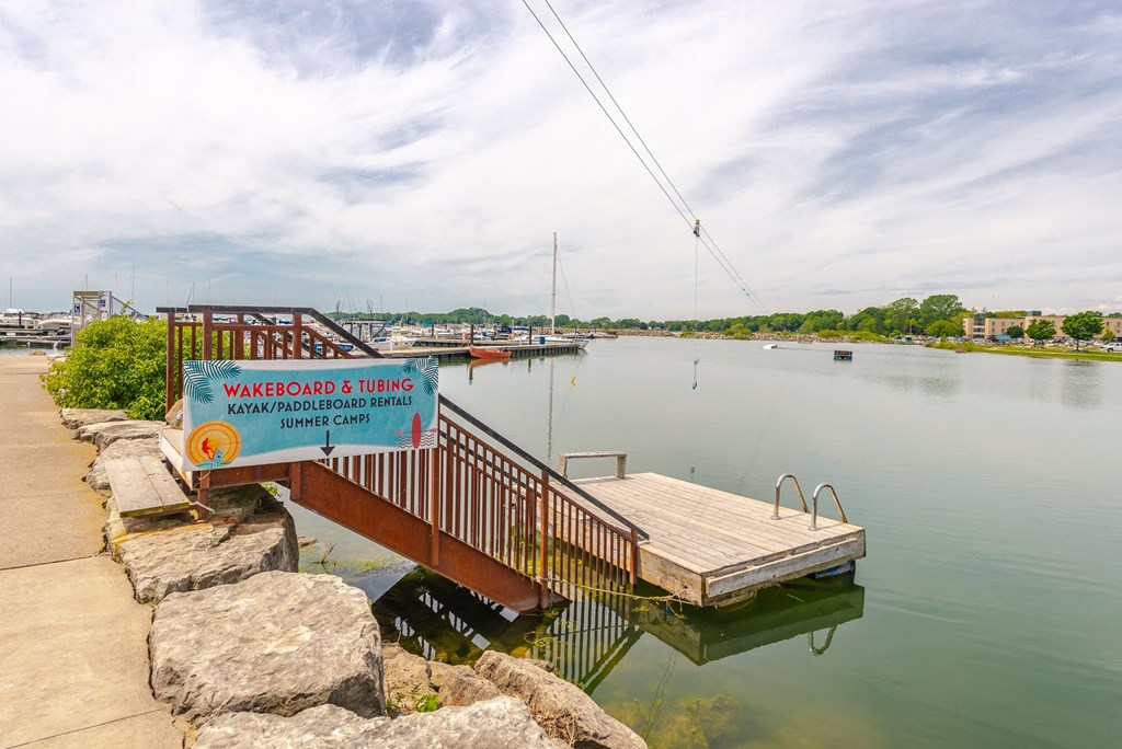 a dock on the water with a sign on it