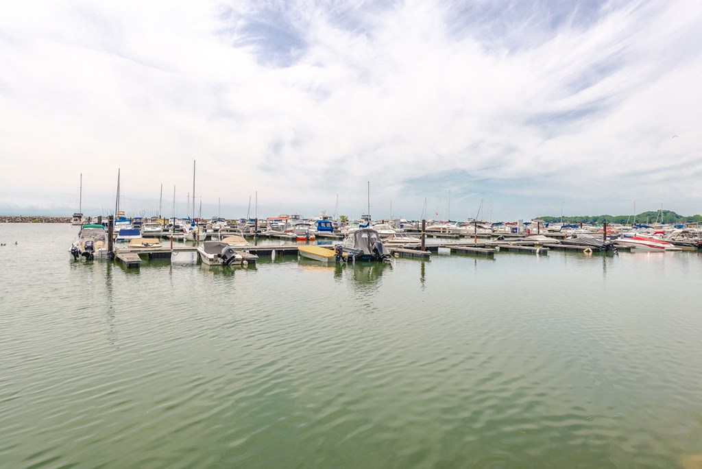 a group of boats docked at a marina on the water