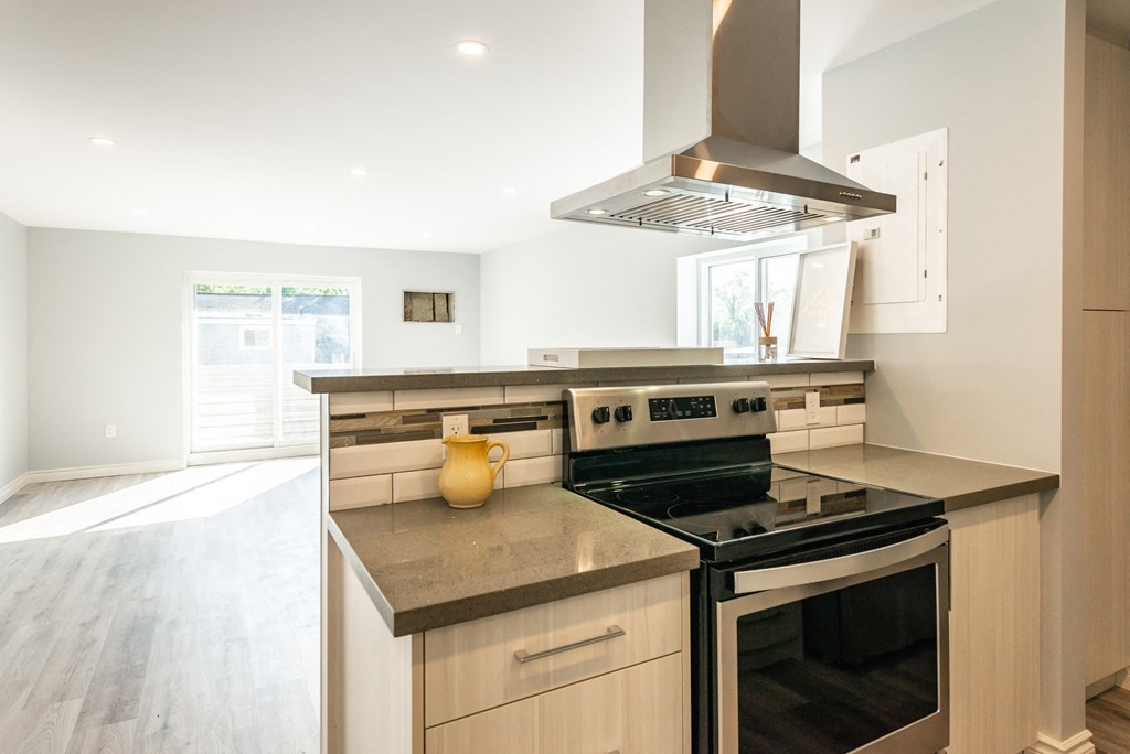 a modern kitchen with a stove and a microwave