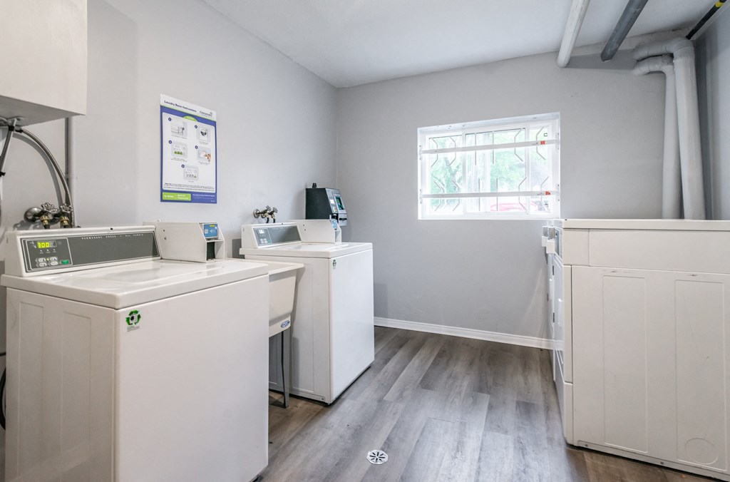 a kitchen with white appliances and a window