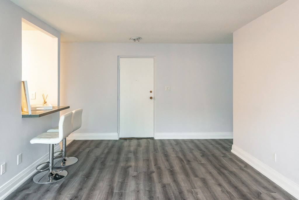 an empty room with a desk and a chair in it