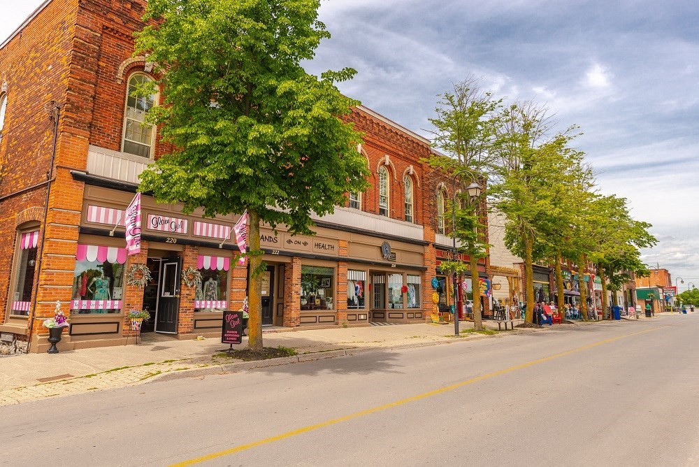 a city street with shops on the side of a street