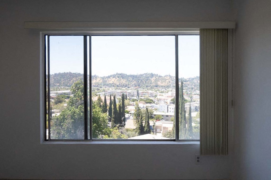the view of the city from the window of a living room