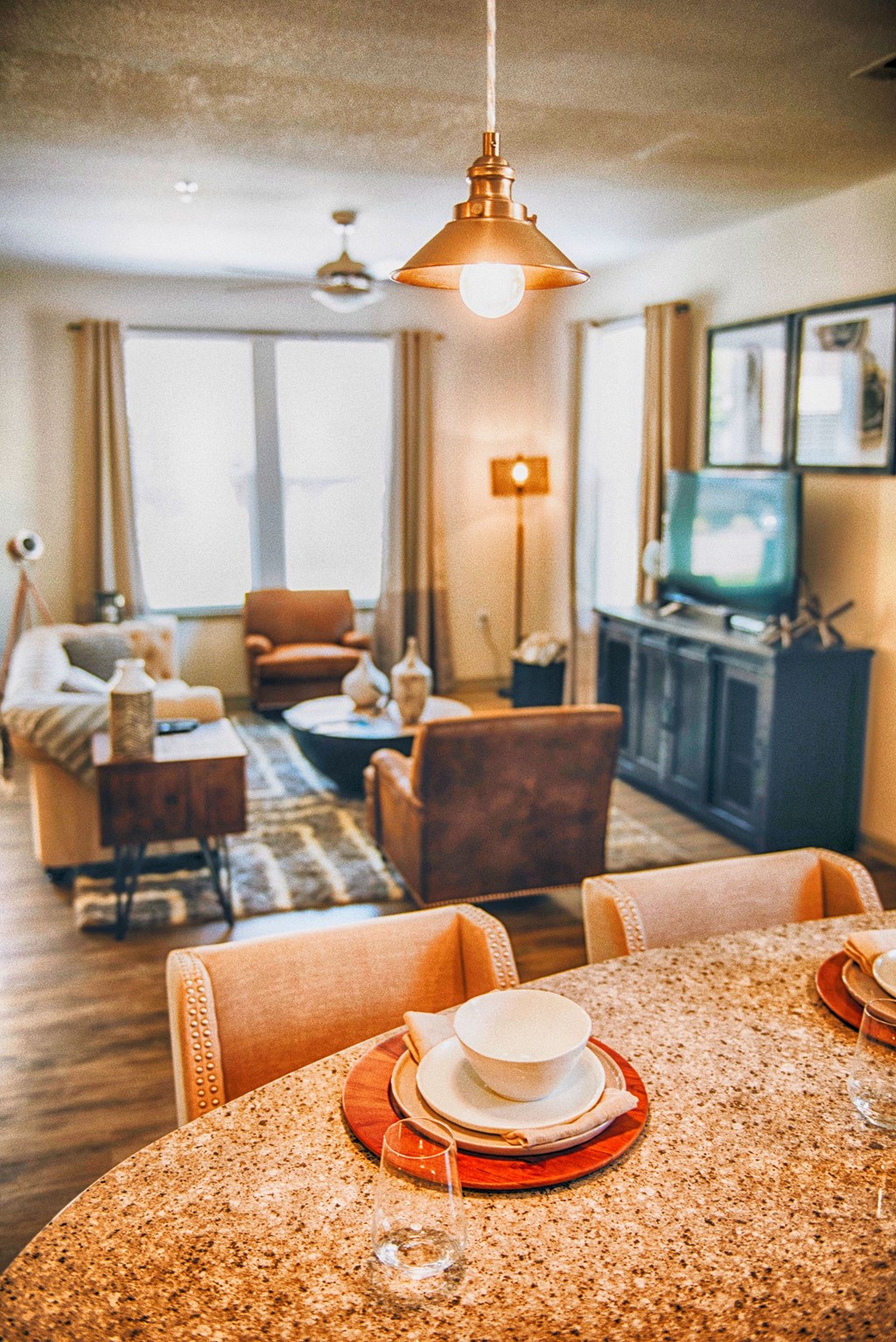 a living room filled with furniture and a table with a hat on it