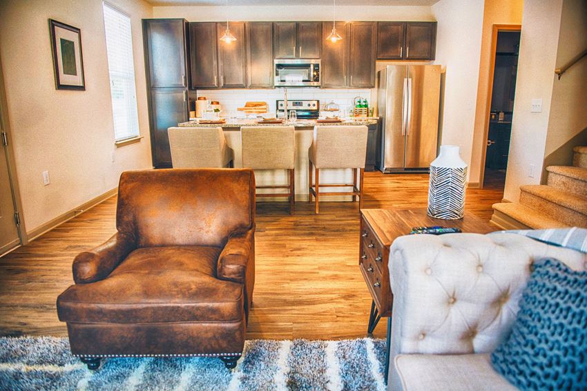 a living room and kitchen with a couch and a table