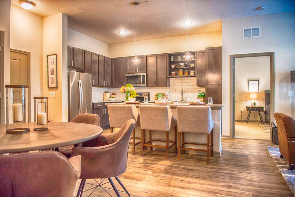 a kitchen and dining room with a table and chairs