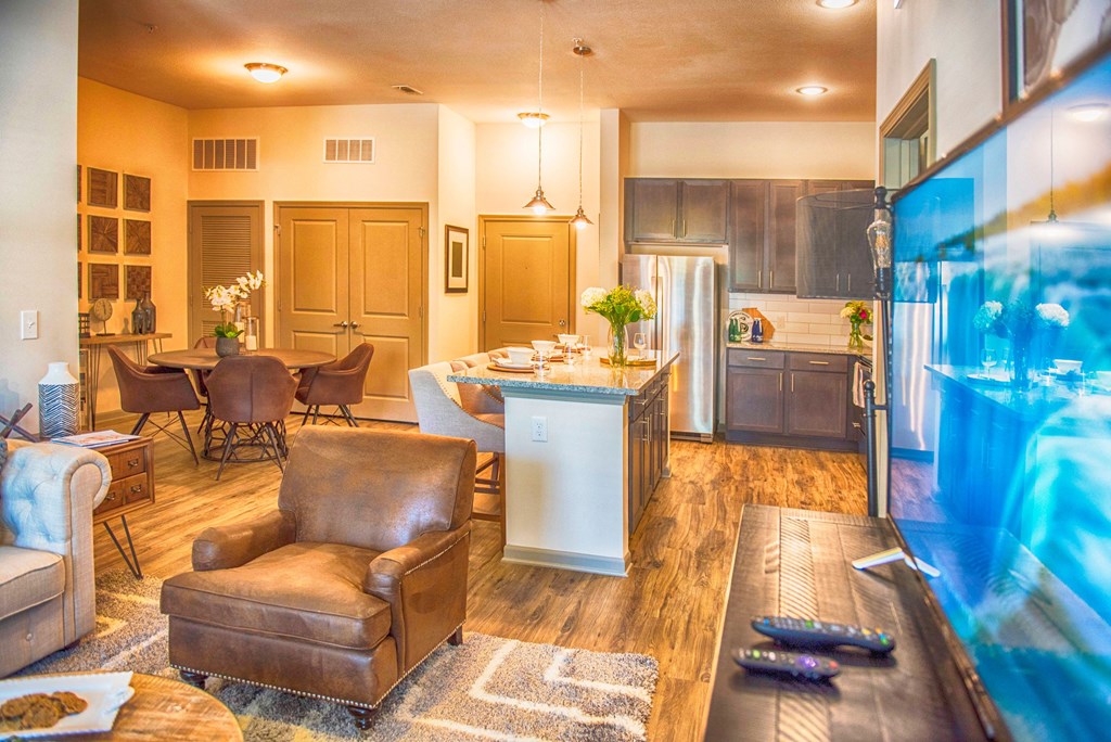 a living room and kitchen with a large aquarium
