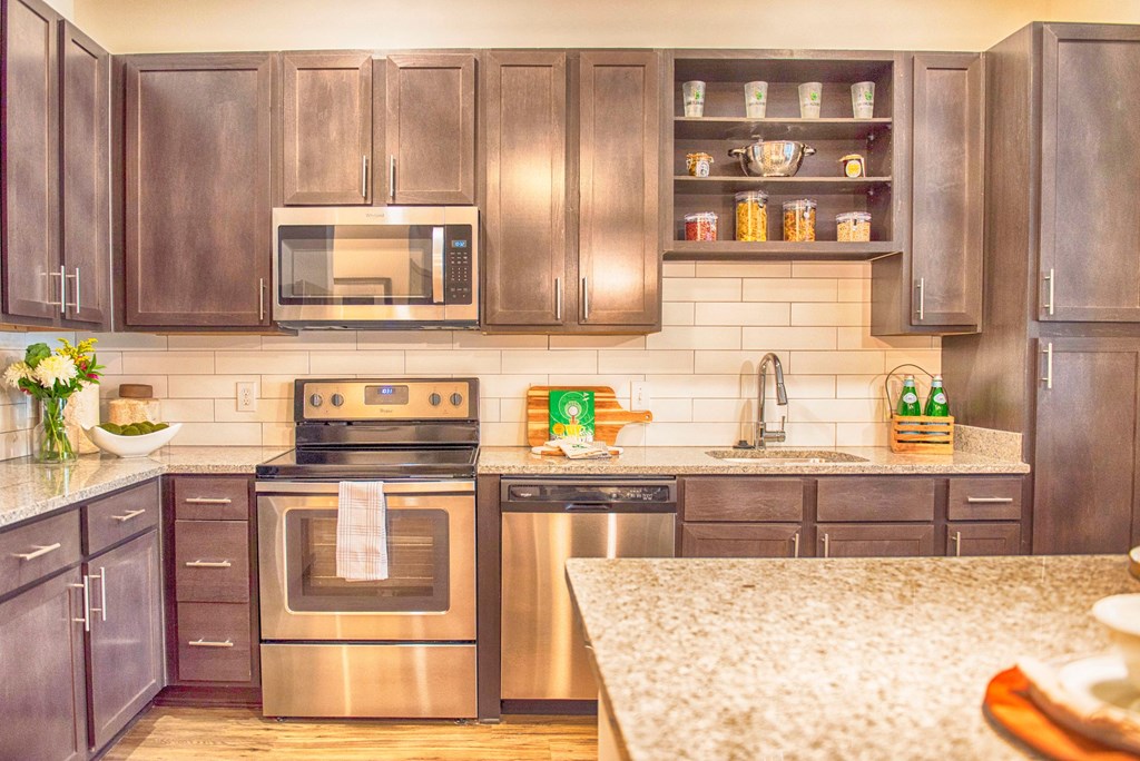 a kitchen with stainless steel appliances and wooden cabinets