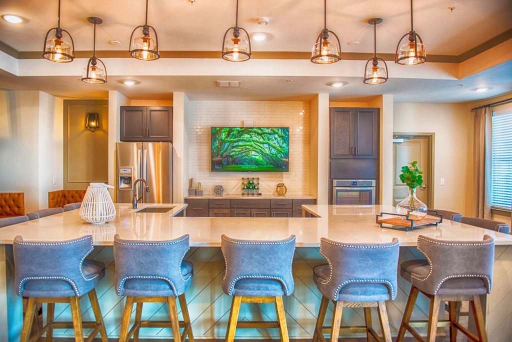 a kitchen with a large island with bar stools