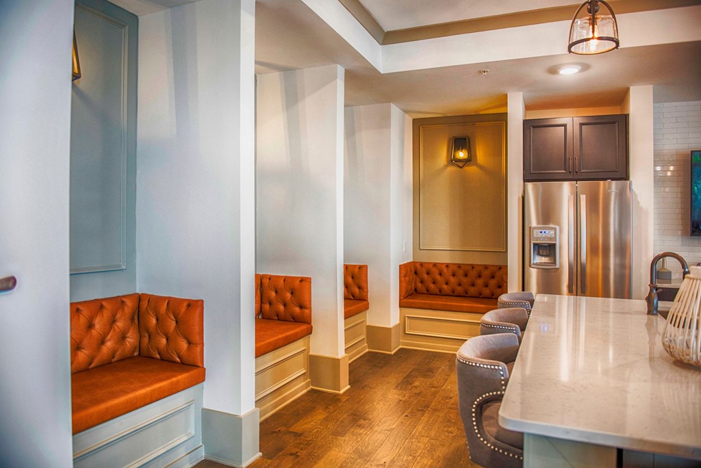 a kitchen and living room with couches and a table