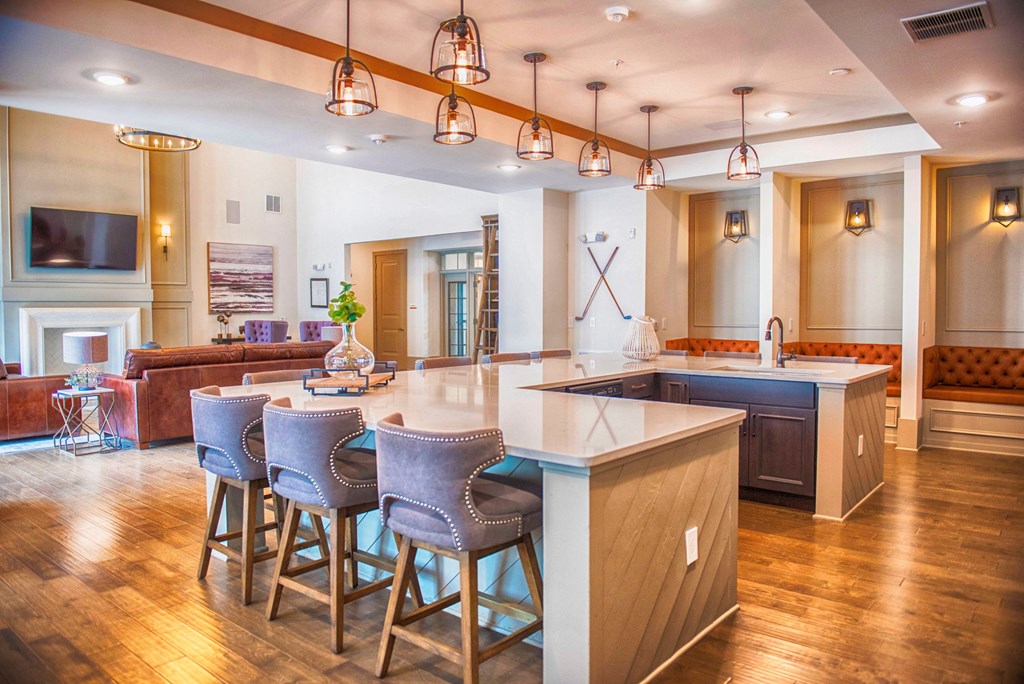 a large kitchen with a center island and bar stools