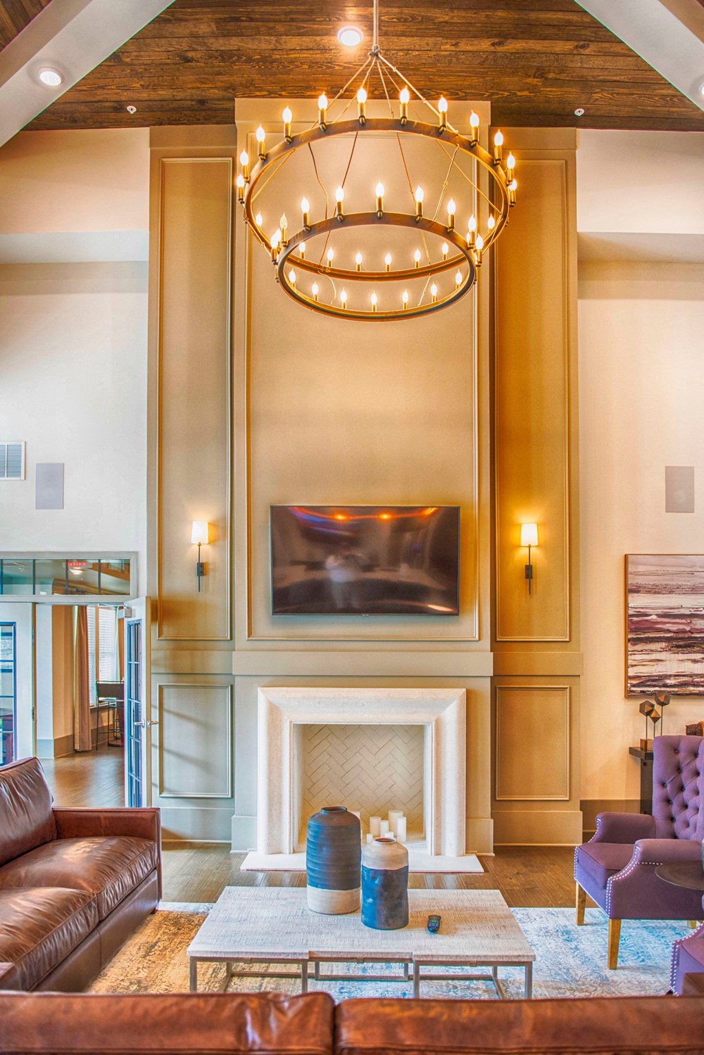 a living room with a fireplace and a chandelier