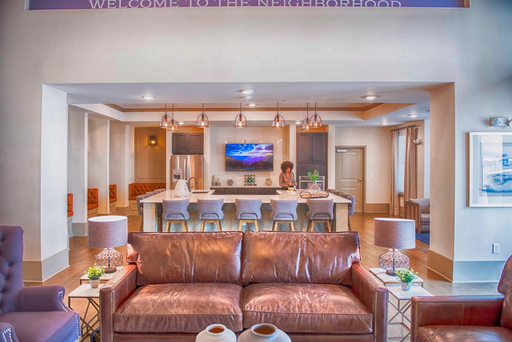 a living room with a couch and a kitchen with a table and chairs