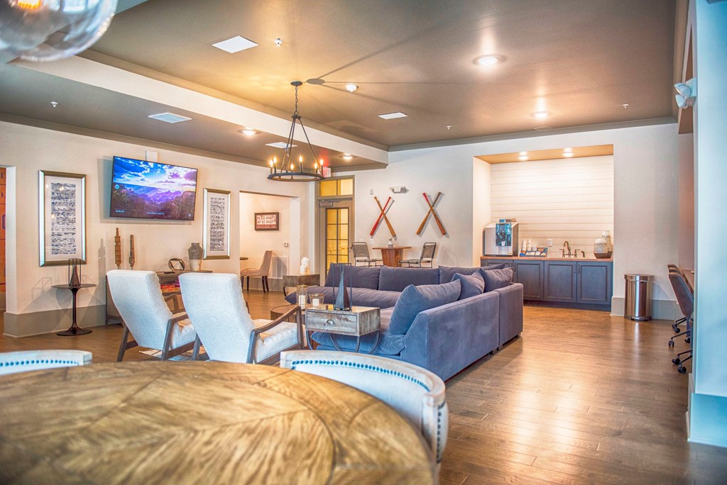 a living room with couches and chairs and a table