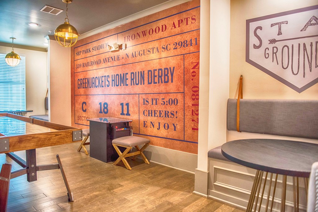 a room with a piano and a table and a sign on the wall