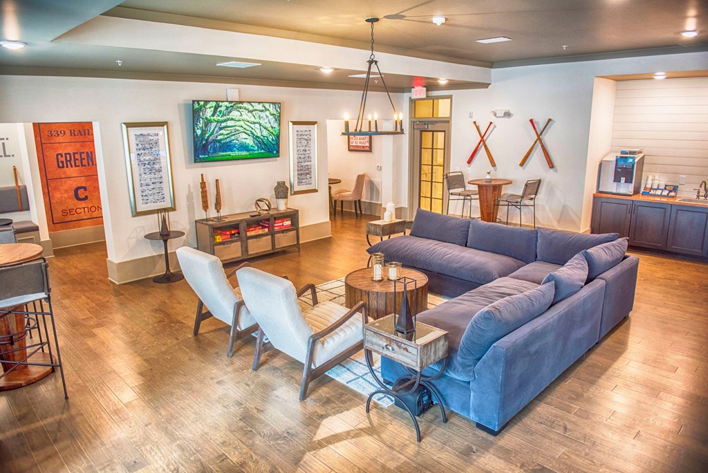 a living room with a blue couch and a table and chairs