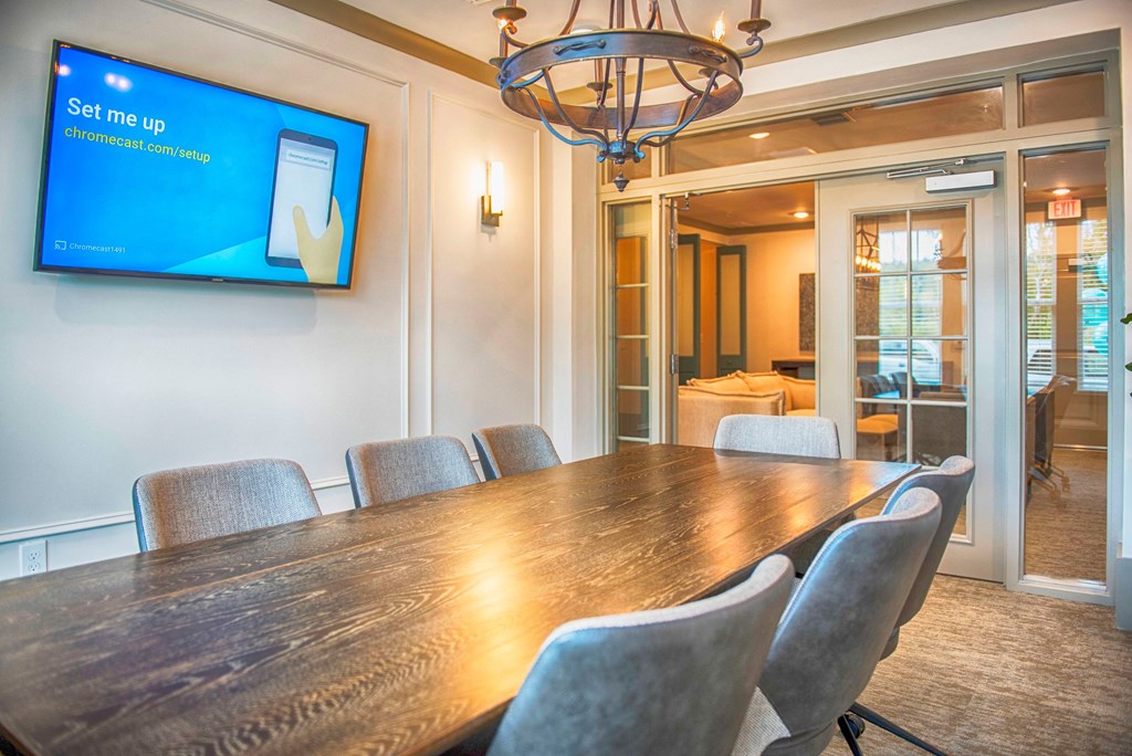 a conference room with a long wooden table and chairs