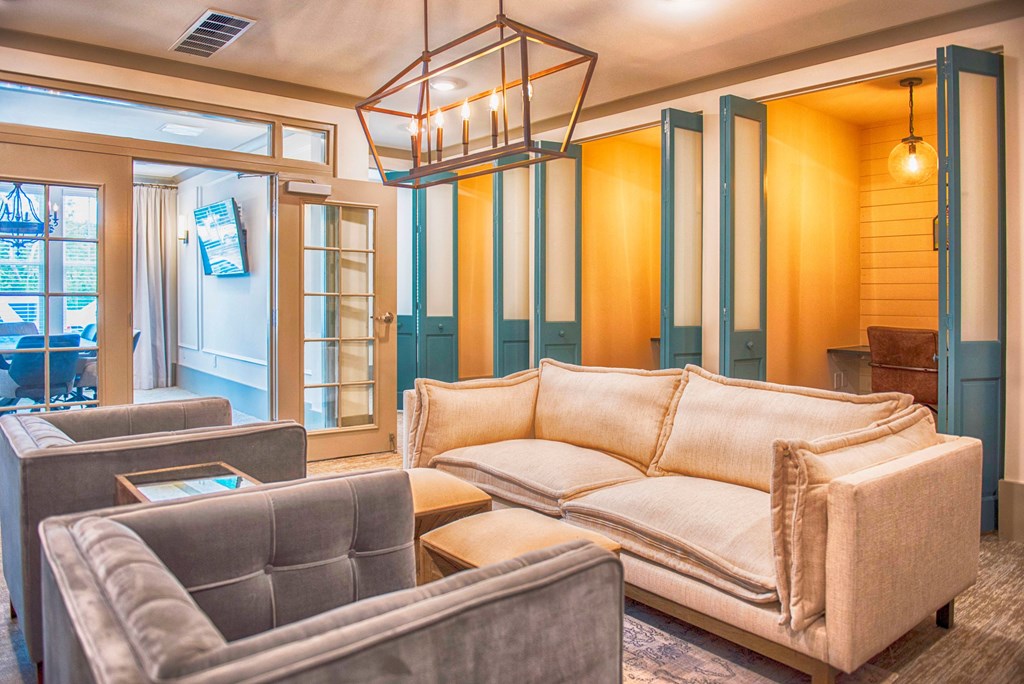 a living room with couches and chairs and a chandelier