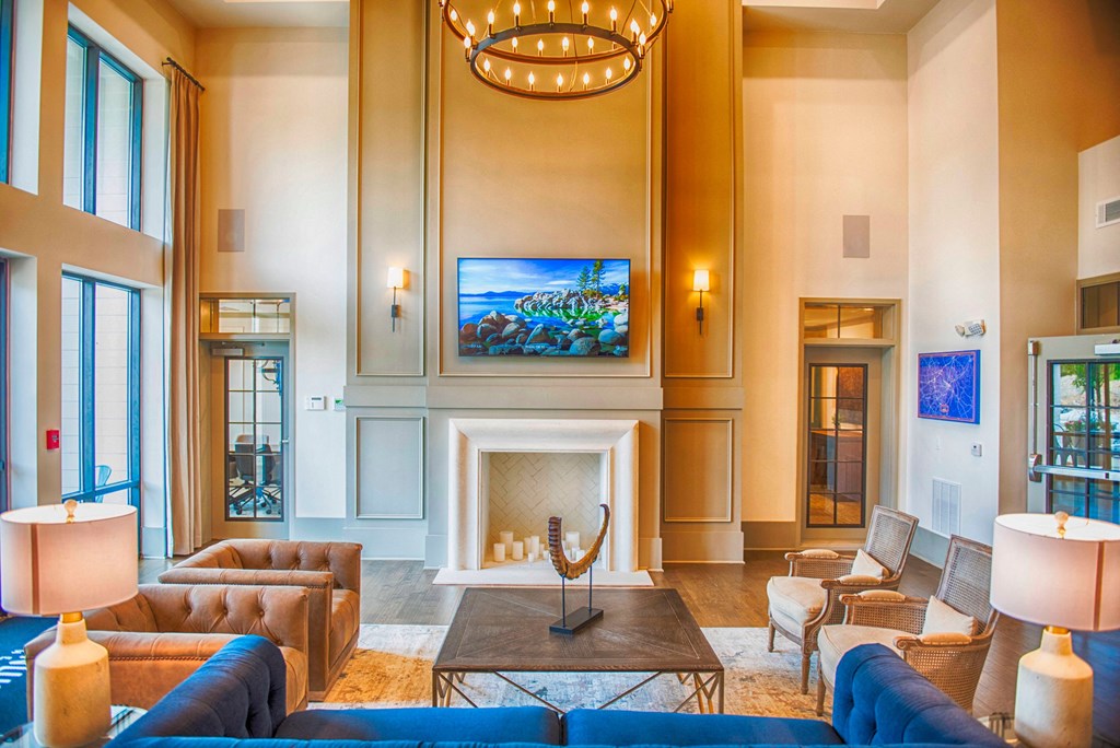 a living room with couches and chairs and a fireplace