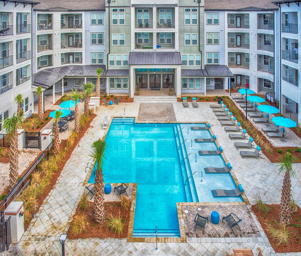 an aerial view of an apartment building with a swimming pool