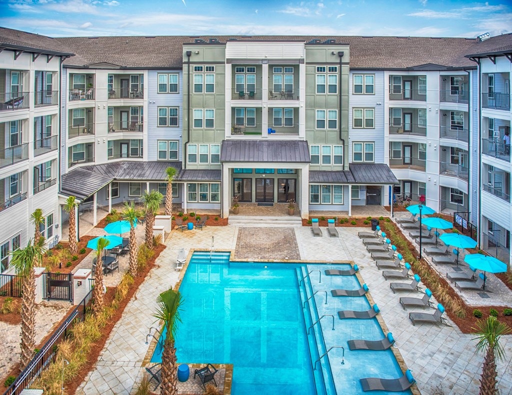 an overhead view of an apartment building with a swimming pool