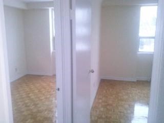 an empty room with a white door and a tile floor