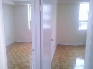 an empty room with a white door and a tile floor