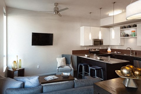 a living room with a couch and a kitchen